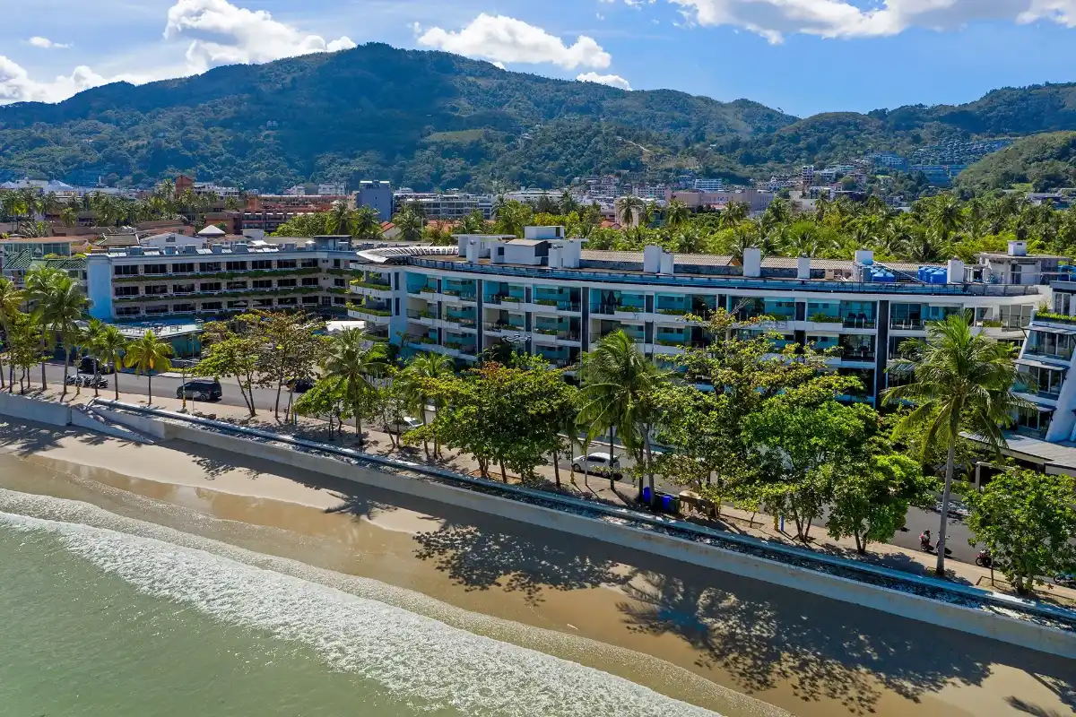 Aerial view of Homm Bliss Southbeach Patong building along Patong Beach beachfront road with sea access