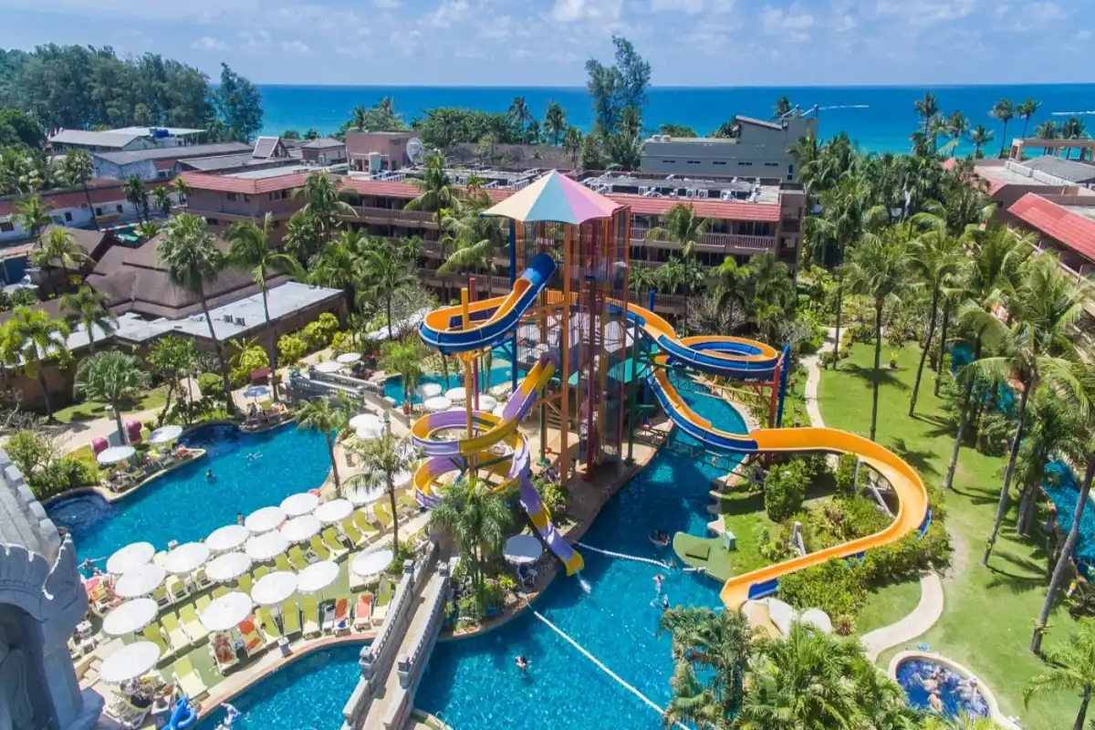 High aerial view of giant colorful water slides and outdoor pool complex at Phuket Orchid Resort and Spa near Karon Beach.