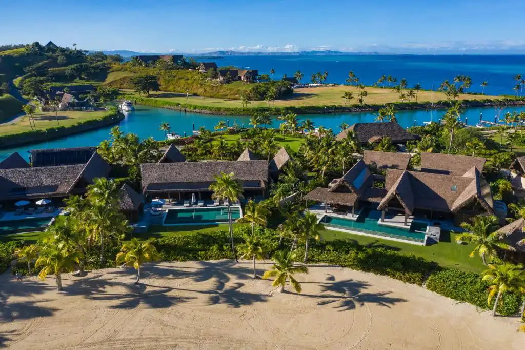 Aerial view of Six Senses Fiji on Malolo Island showing private pool villas, beachfront, and private marina channel.
