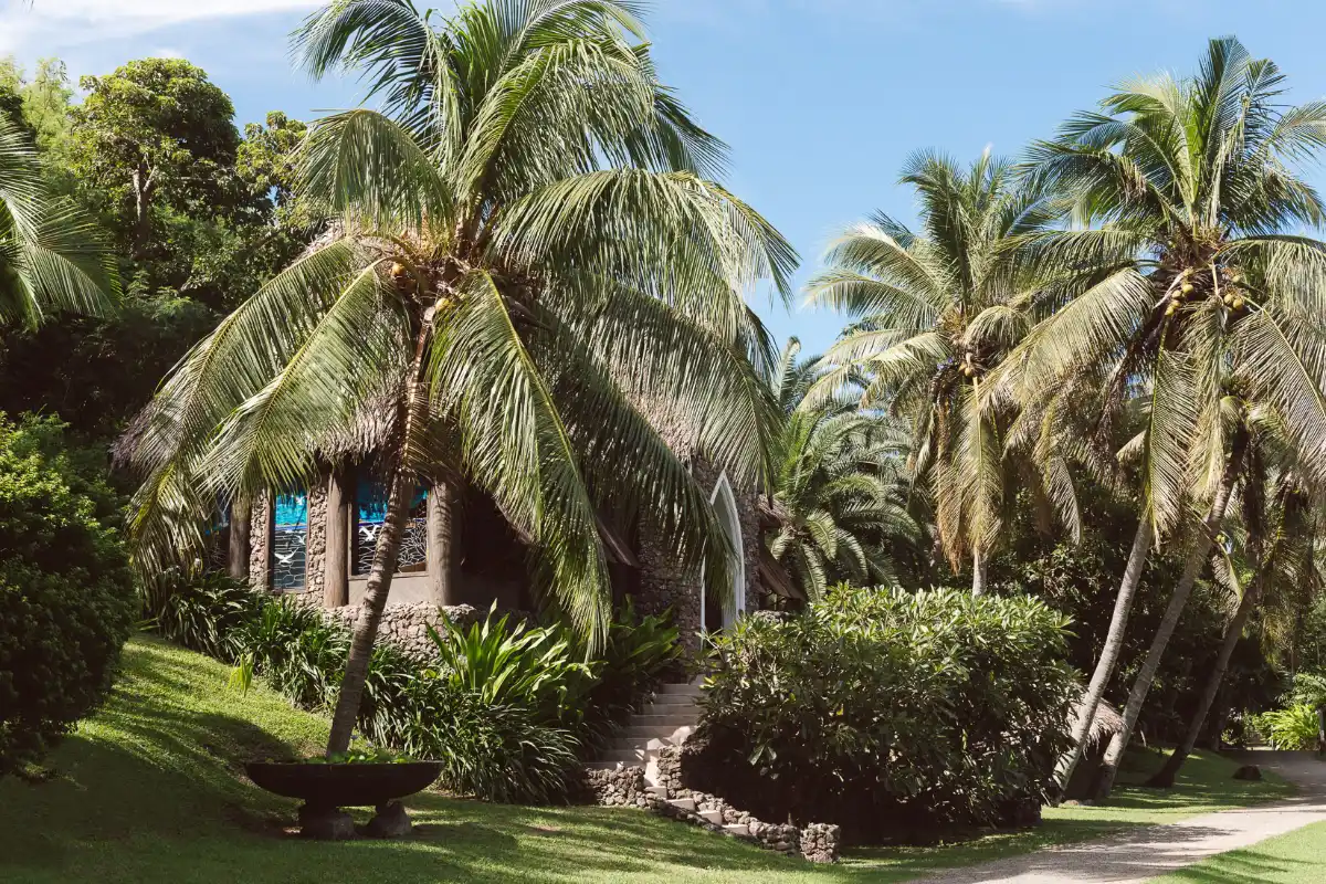Stone wedding chapel surrounded by palm trees and tropical gardens at Tokoriki Island Resort Fiji.