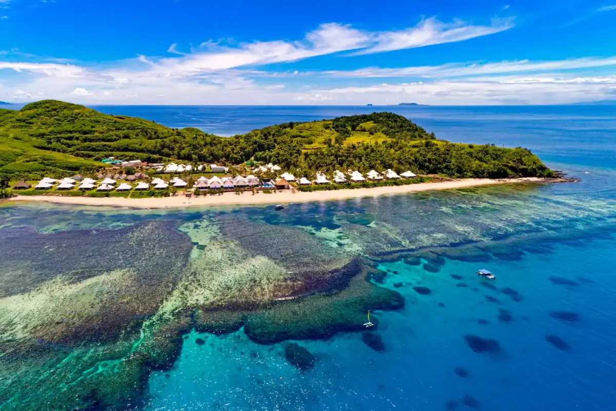 Aerial view of Sheraton Resort & Spa Tokoriki Island Fiji beachfront accommodations and surrounding coral reef structure.