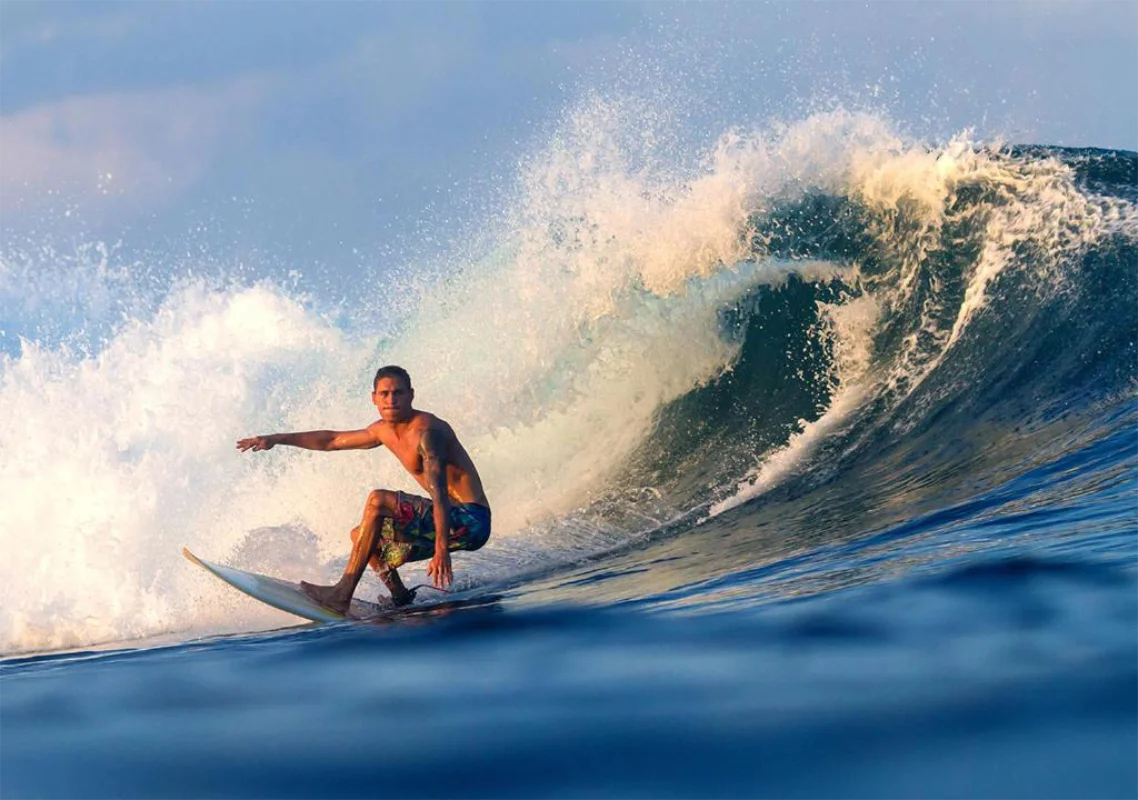 Male surfer riding a wave near Anantara Uluwatu Bali Resort at Impossibles Beach.