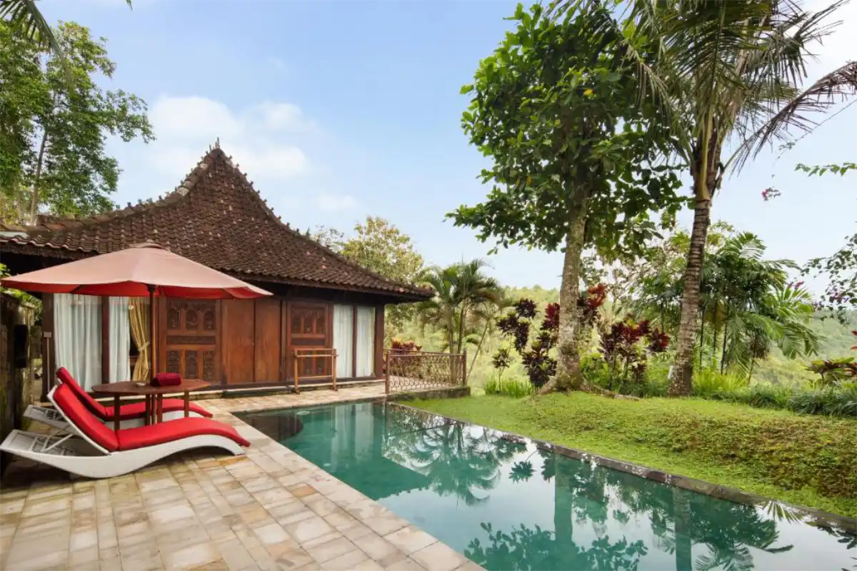 Wooden private pool villa with sun loungers at Ayung Resort Ubud in Payangan Bali.