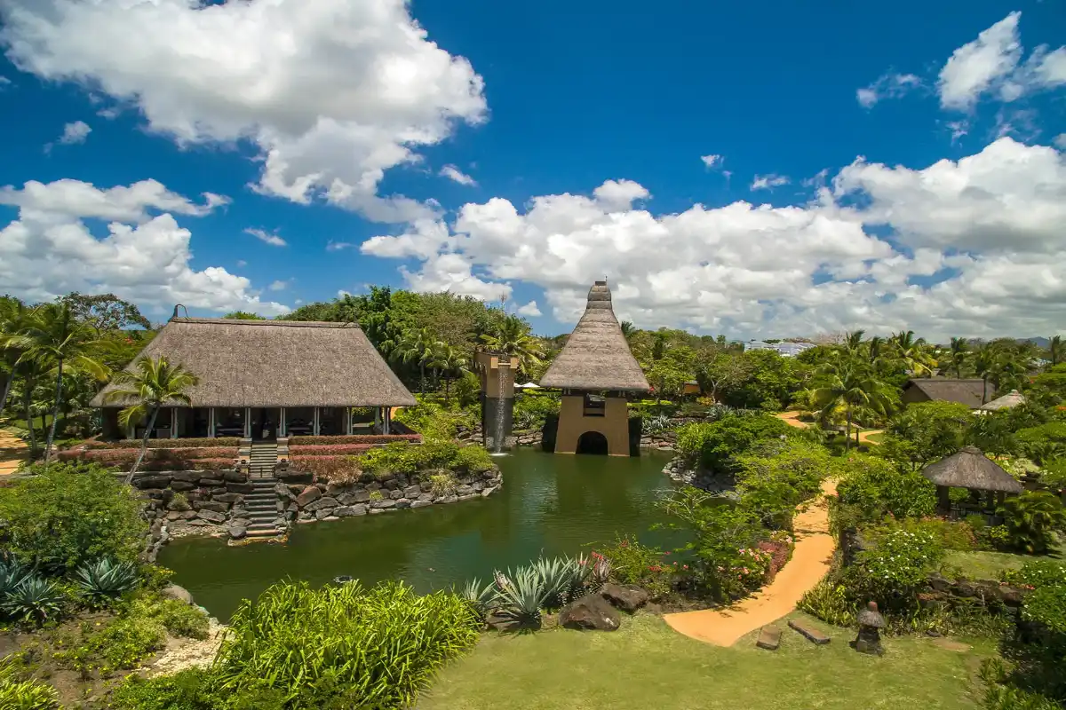 A luxury honeymoon villa at The Oberoi Beach Resort Bali, featuring a tropical garden and ocean views.
