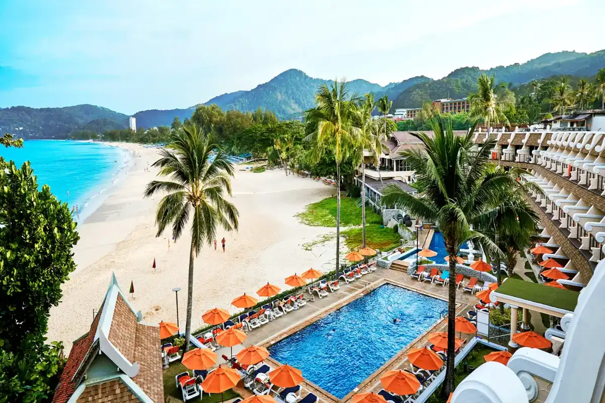 Direct beachfront outdoor pool and orange sun loungers at Beyond Karon Adults Only hotel on Karon Beach Phuket