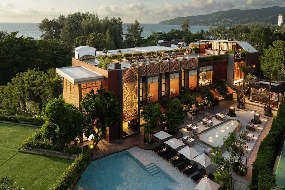 Aerial view of the outdoor swimming pool, rooftop venue, and Karon Beach ocean view at Avista Grande Phuket Karon - MGallery.