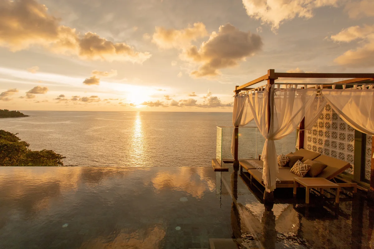 Infinity pool and sunbed gazebo with ocean sunset view at The Shore at Katathani pool villas