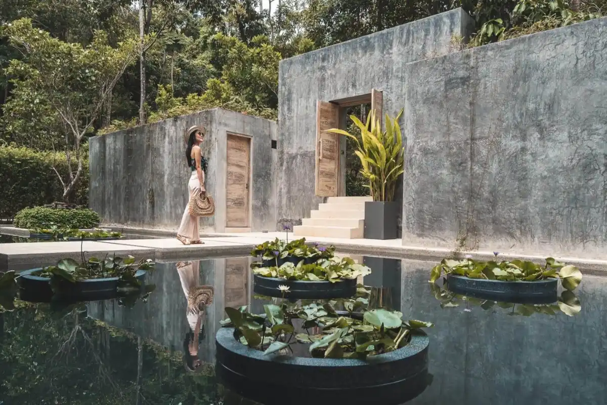 Lotus pond and brutalist concrete design at the entrance of Spa Burasari at Island Escape Phuket.