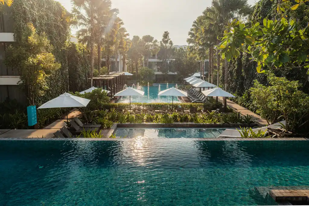 Outdoor saltwater swimming pool and tropical grounds at Stay Wellbeing Resort Phuket in Rawai.
