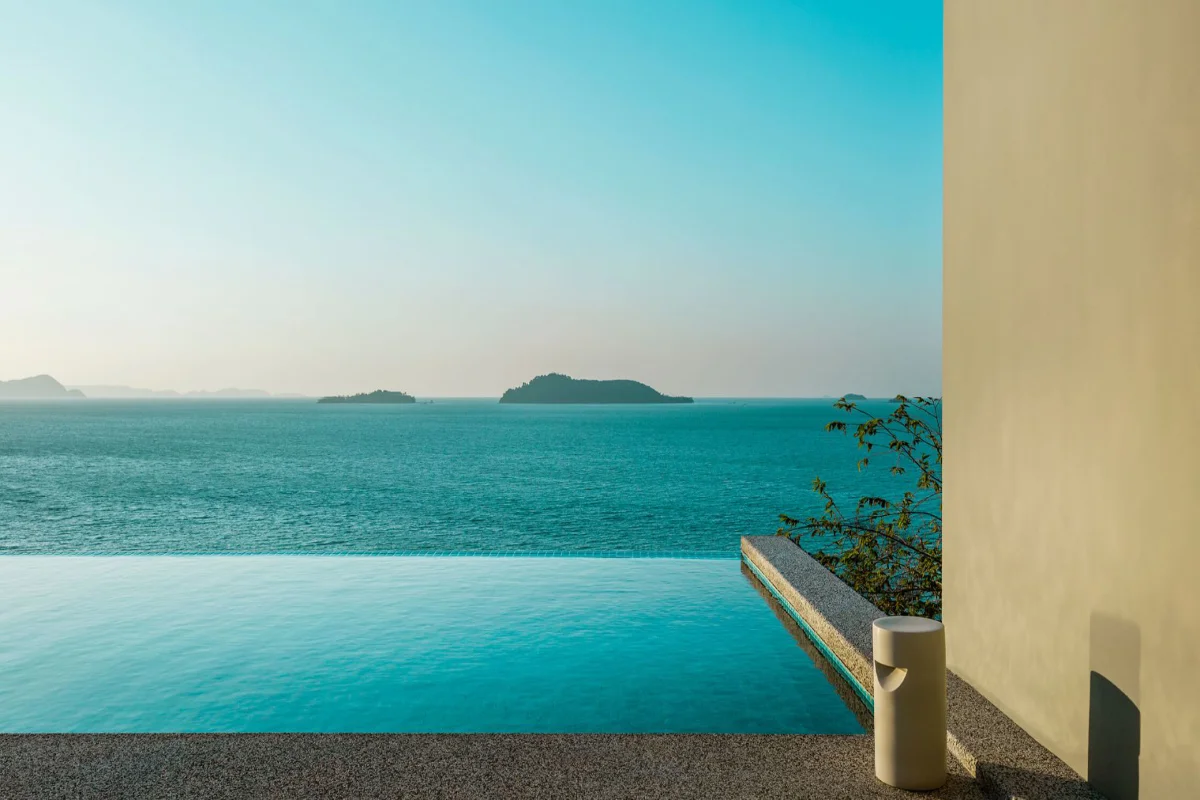 Infinity swimming pool at COMO Point Yamu Phuket overlooking Phang Nga Bay islands and clear blue water.
