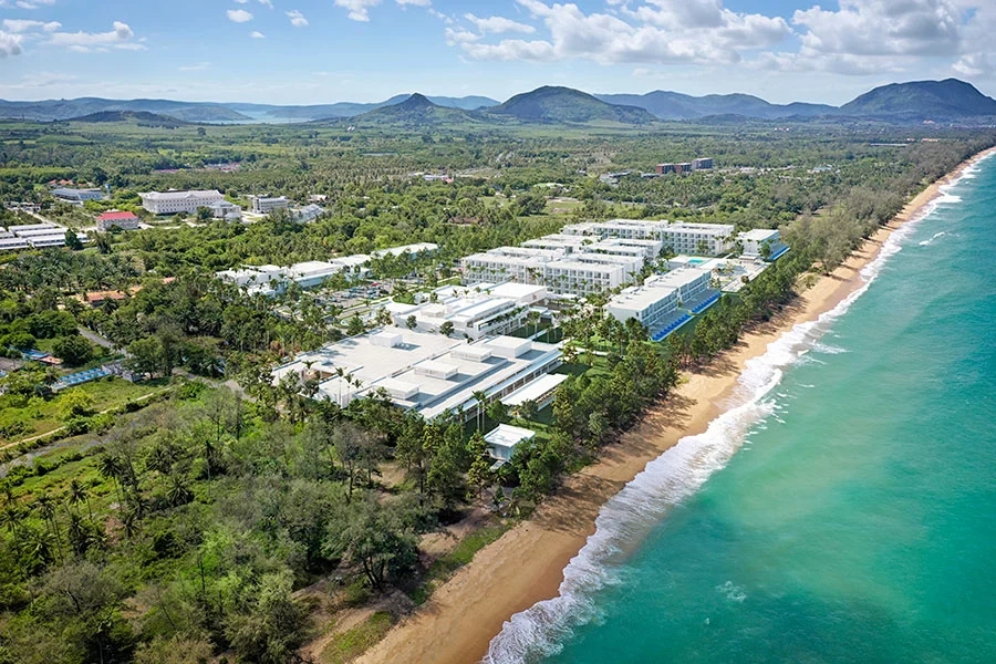 Aerial view of Hotel Riu Palace Phuket resort layout, outdoor pools, and beachfront positioning along Mai Khao Beach.