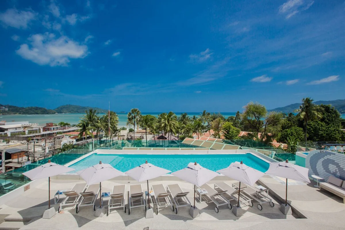 Rooftop swimming pool and sun loungers at The Bloc Hotel Phuket overlooking Patong Beach