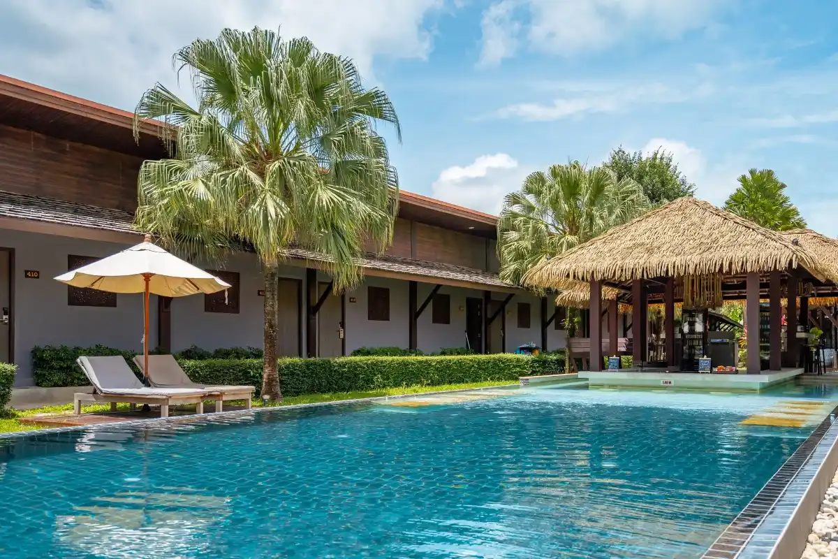 Pool Villa Phuket main outdoor swimming pool with sun loungers and thatched roof gazebo