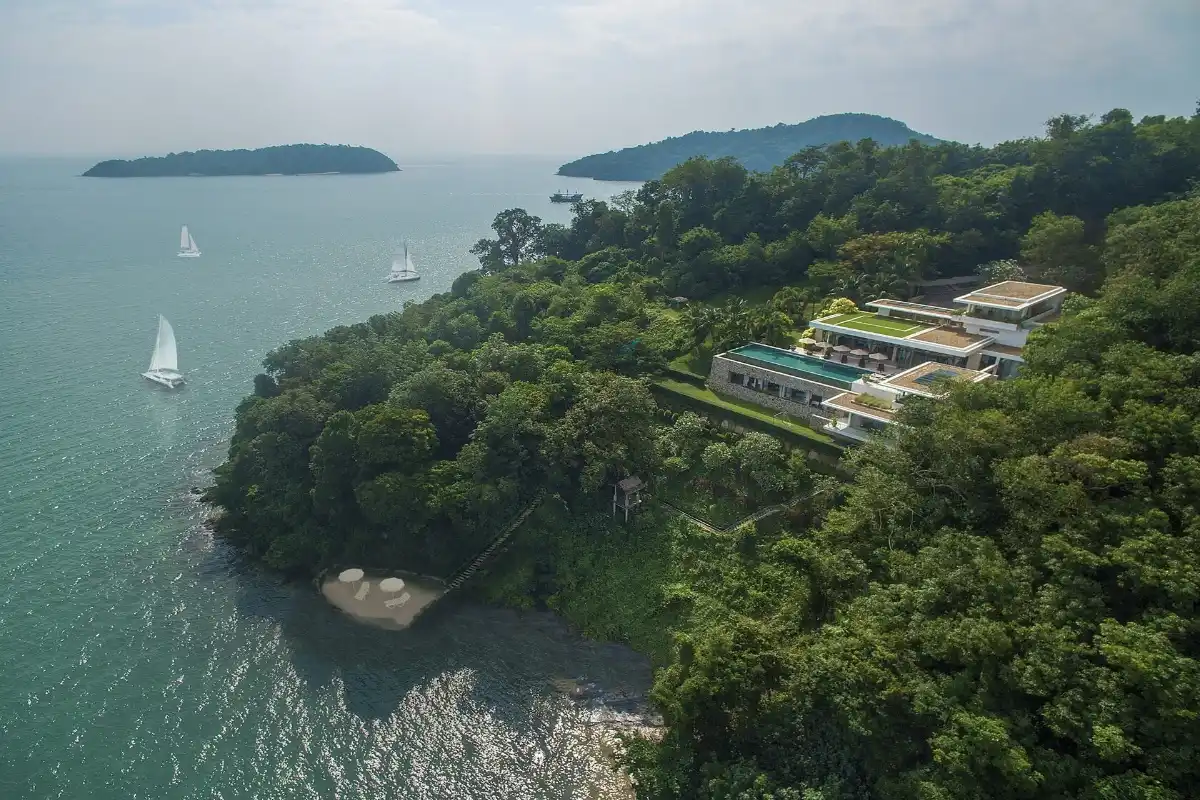 Aerial view of Villa Skyfall Phuket at Cape Panwa featuring the infinity pool, private beach access, and surrounding ocean view.